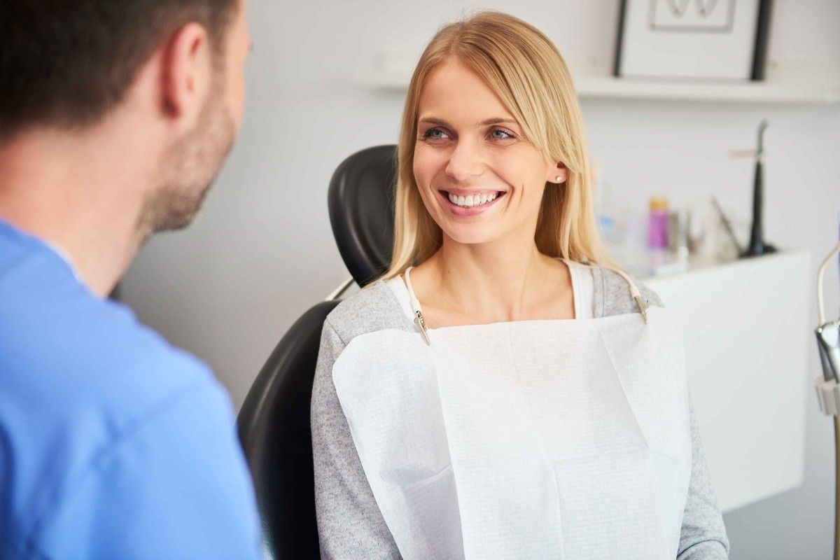 Dentist discussing dental sealants with a patient during a preventive dental consultation
